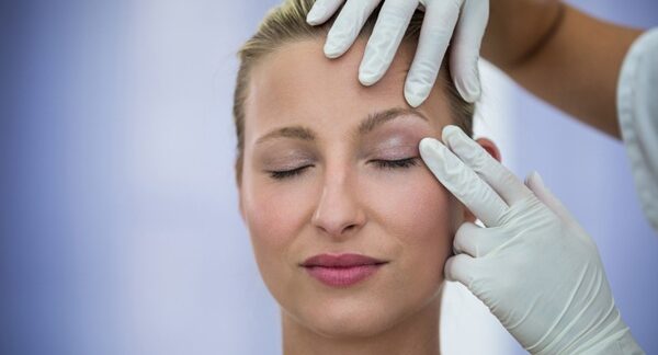 Cirujanos de blefaroplastia - Uno de los mejores cirujanos de blefaroplastia en Valencia evaluando a una mujer para tratar los párpados caídos