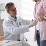 Especialistas del sistema digestivo - Mujer en consulta de gastroenterología siendo evaluado por un médico aparato digestivo reconocido como el mejor gastroenterólogo en Valencia