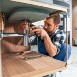 Empresas de fontanería - Fontanero de una de las mejores empresas de fontanería en Valencia realizando un trabajo de plomería