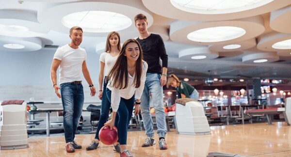 Clubes de bolos - Personas en una pista de boliche jugando bowling en uno de los mejores clubes de bolos de Valencia